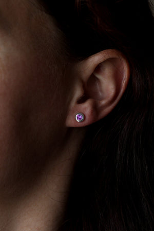 Model wearing amethyst stud earrings